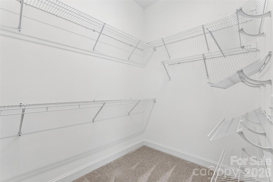 Primary bedroom walk in closet