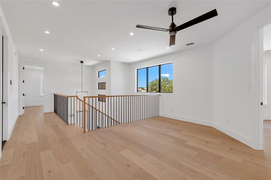 Spare room with light wood-style flooring, recessed lighting, and a ceiling fan Spare room with light wood-style flooring, recessed lighting, and a ceiling fan