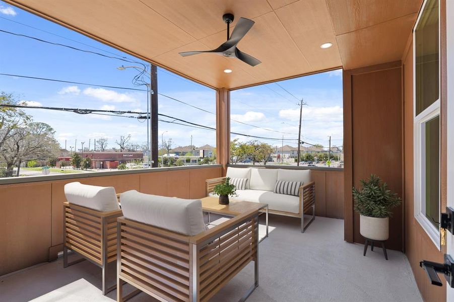 Virtually Staged: Relax and drink a cup of coffee in this tranquil second floor balcony. It features wood ceiling details, a ceiling fan, and recessed lighting.