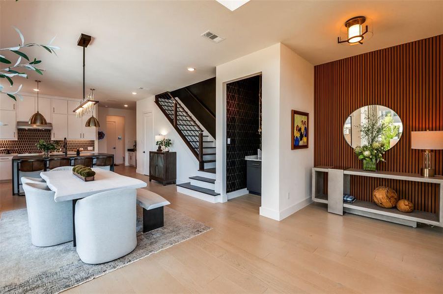 View from dining area to stair and dry bar.