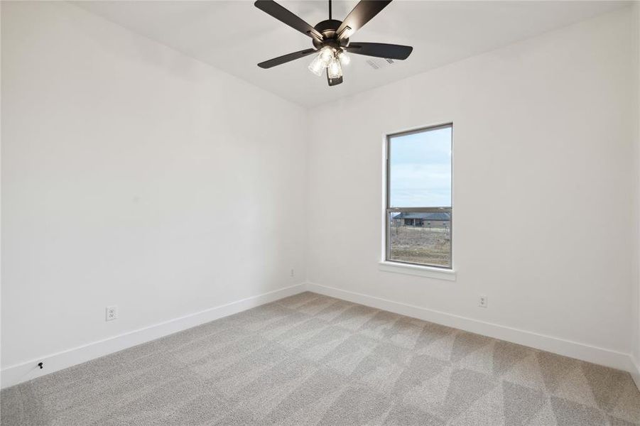 Unfurnished room featuring light carpet and ceiling fan