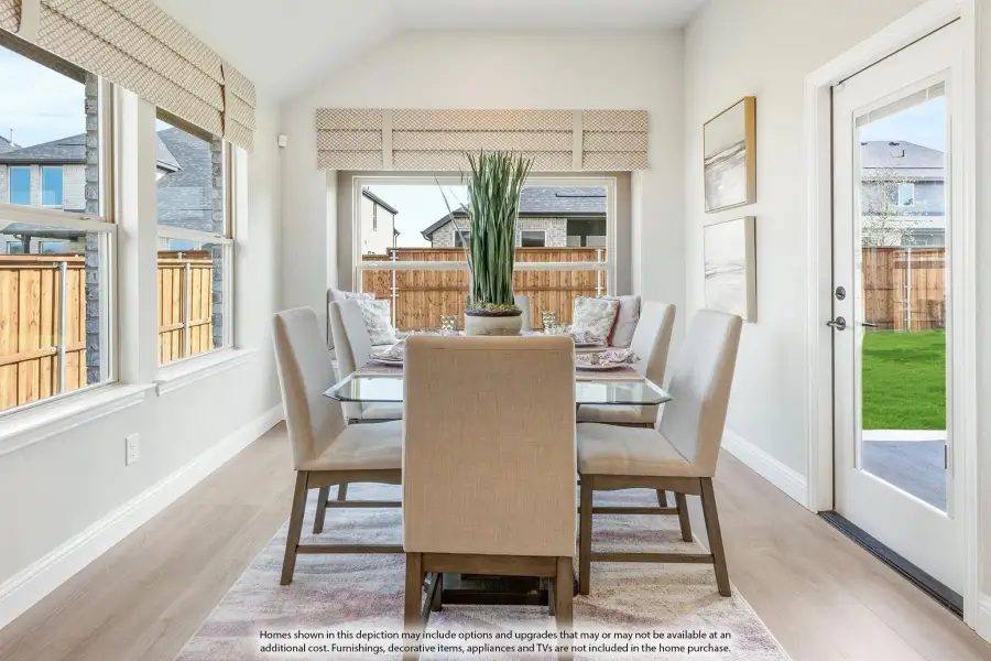 Bright dining room with glass table, six upholstered chairs, hardwood floors, and large windows overlooking a backyard. Bright dining room with glass table, six upholstered chairs, hardwood floors, and large windows overlooking a backyard.