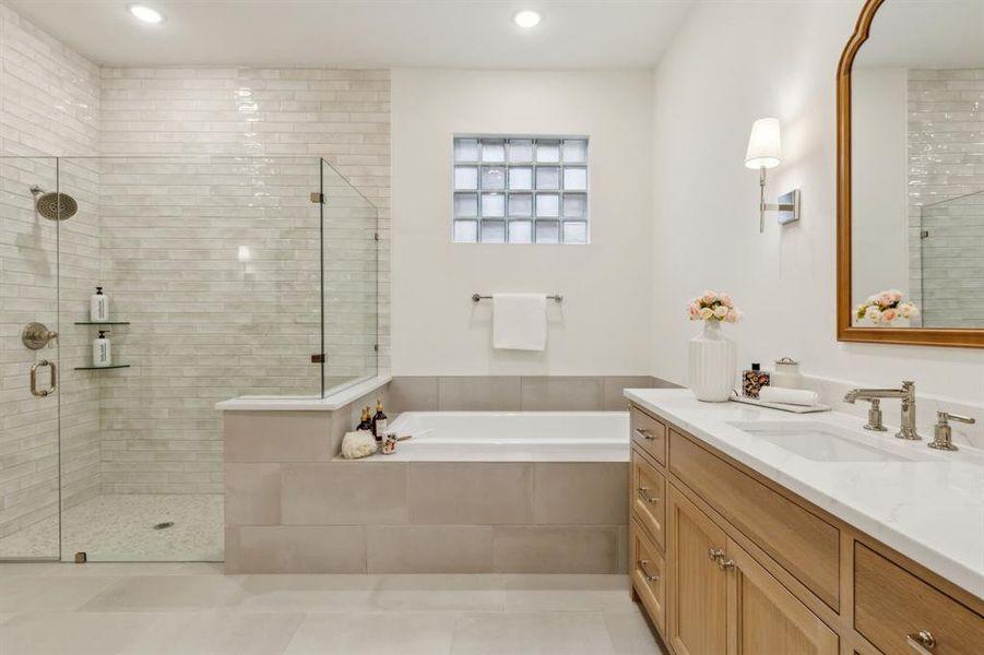 Bathroom with vanity, tile patterned flooring, and plus walk in shower