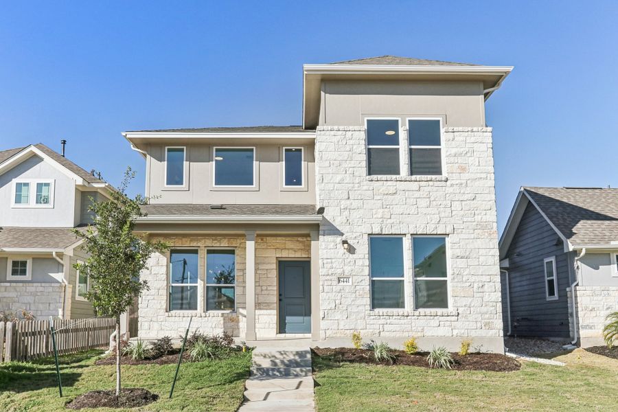 Front exterior of a new home in Porter Country, Buda, TX, highlighting curb appeal (Image 1). Front exterior of a new home in Porter Country, Buda, TX, highlighting curb appeal (Image 1).