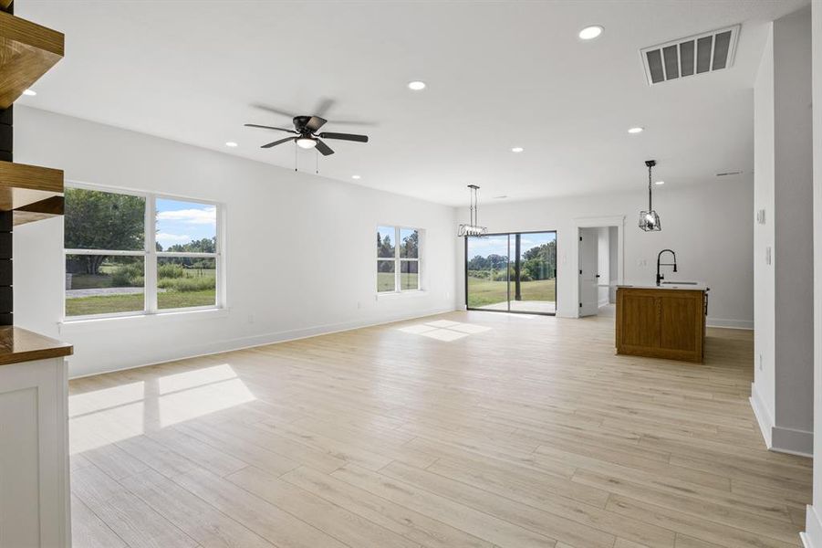 Unfurnished living room featuring recessed lighting, light wood-style flooring, and ceiling fan
