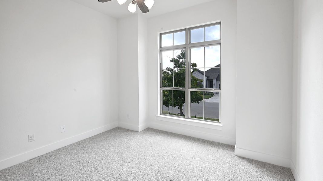 Unfurnished room with carpet floors and a ceiling fan Unfurnished room with carpet floors and a ceiling fan