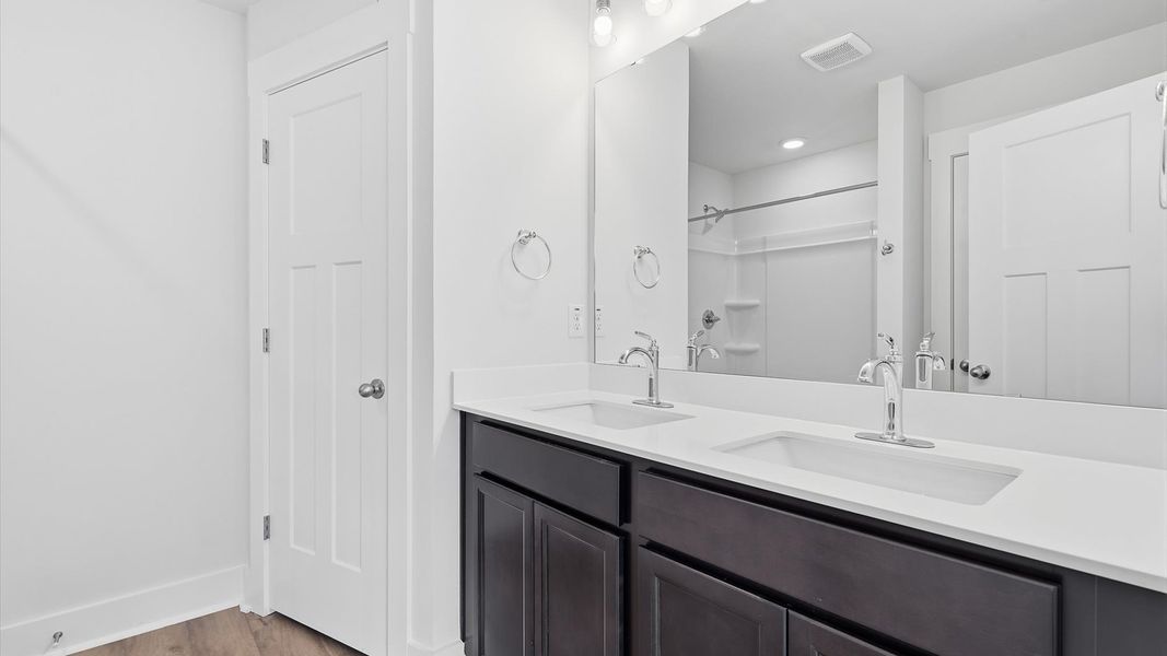 Memorable mornings begin in this elegant primary bathroom with walk-in shower and double vanity in Greenville, SC
