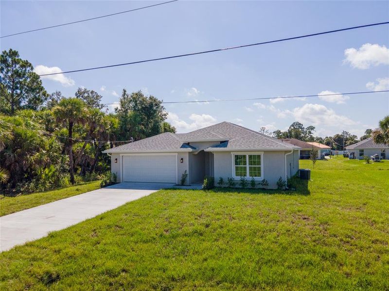 Front exterior of a new home in , North Port, FL, highlighting curb appeal (Image 17). Front exterior of a new home in , North Port, FL, highlighting curb appeal (Image 17).