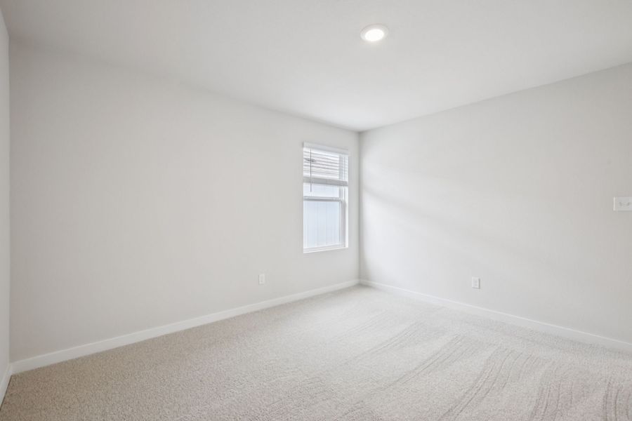 A room with a bed and a window.