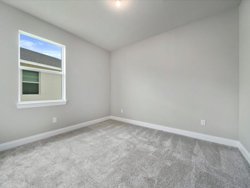 Bedroom in the Coral floorplan at 6295 NW Sweetwood Drive in Brystol at Wylder