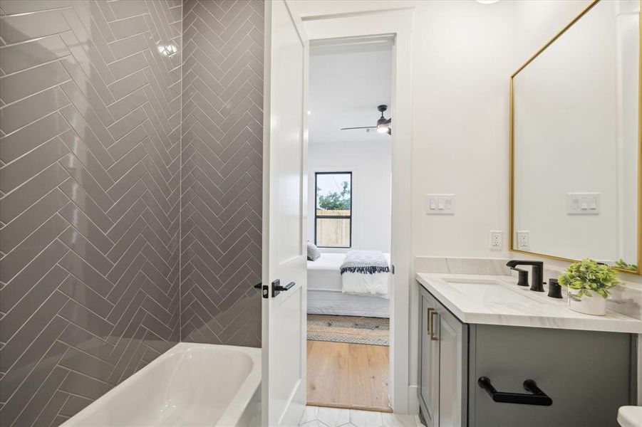 Tub/shower combo with  herringbone pattern subway tile.