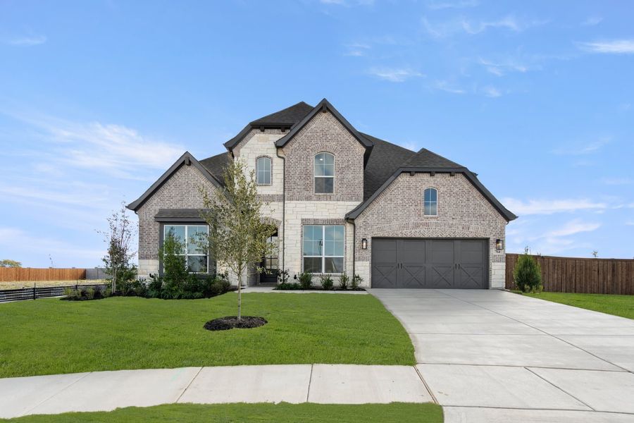 Front exterior of a new home in Myrtle Creek, Waxahachie, TX, highlighting curb appeal (Image 20). Front exterior of a new home in Myrtle Creek, Waxahachie, TX, highlighting curb appeal (Image 20).