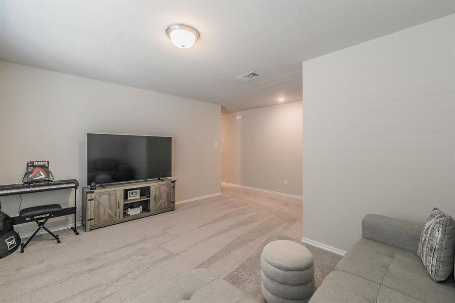 Living room with light carpet and baseboards