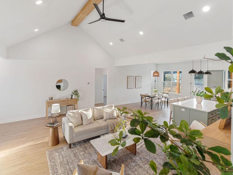 Living room with wood finished floors, a ceiling fan, and recessed lighting