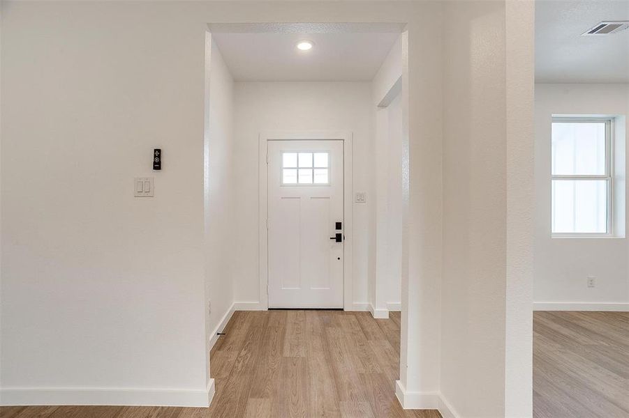 Doorway to outside with light hardwood / wood-style flooring Doorway to outside with light hardwood / wood-style flooring