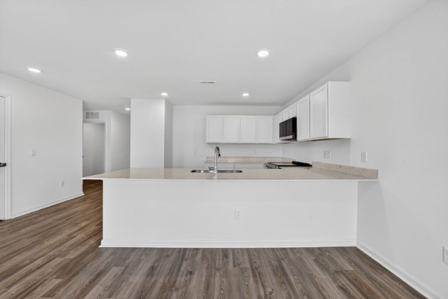 A kitchen with white cabinets.