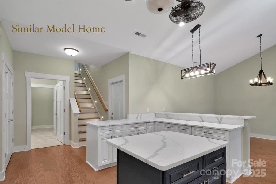 Convenient kitchen layout with laundry and stairs to bonus suite Convenient kitchen layout with laundry and stairs to bonus suite