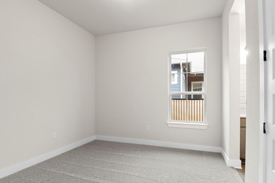 Unfurnished room with baseboards and light colored carpet