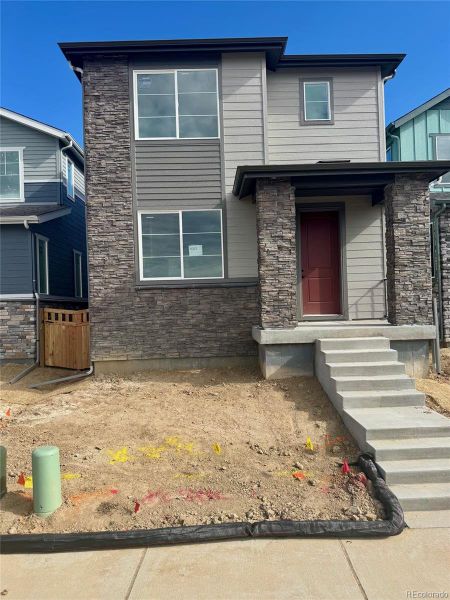 Exterior details and patio area of a home in Painted Prairie, Aurora (Image 3).