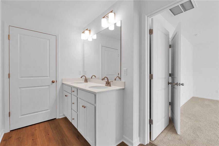 This bright bathroom features a spacious double va This bright bathroom features a spacious double va