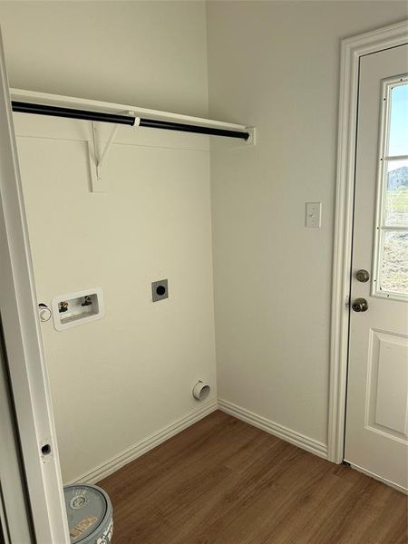 Laundry area featuring dark wood-style floors, washer hookup, and hookup for an electric dryer Laundry area featuring dark wood-style floors, washer hookup, and hookup for an electric dryer