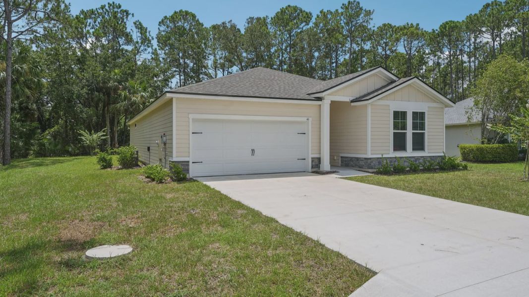 Stone accents add sophistication to this Palm Coast home's exterior at 46 Poplar Drive, enhancing its curb appeal.