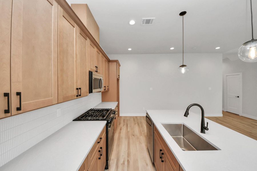 Another view of kitchen with large island and abundance of counter sapce.