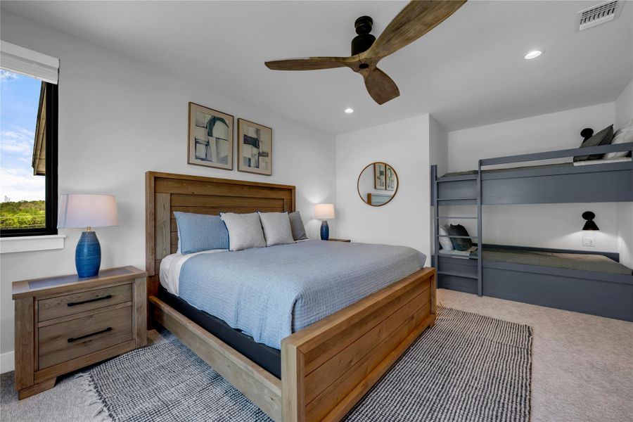 Bedroom five: featuring a wood-finish bed frame, built-in bunk beds, a ceiling fan with wooden blades, a large window, and recessed lighting