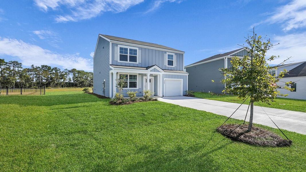 Front exterior of a new home in Hillcrest, Ravenel, SC, highlighting curb appeal (Image 24). Front exterior of a new home in Hillcrest, Ravenel, SC, highlighting curb appeal (Image 24).