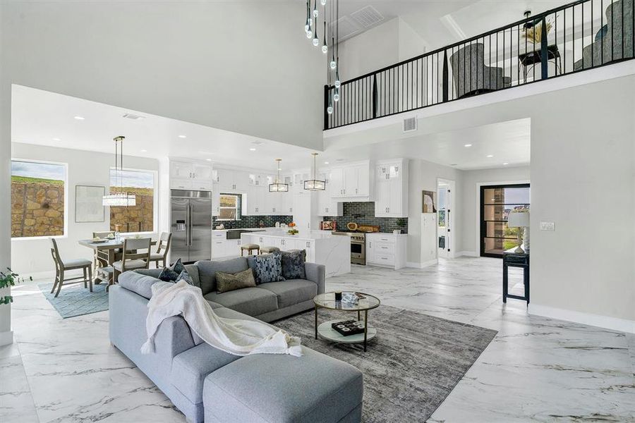 Living room featuring a high ceiling and plenty of natural light