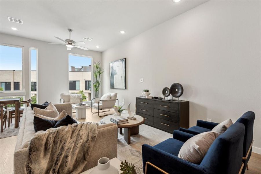 Living room featuring light hardwood / wood-style flooring and ceiling fan