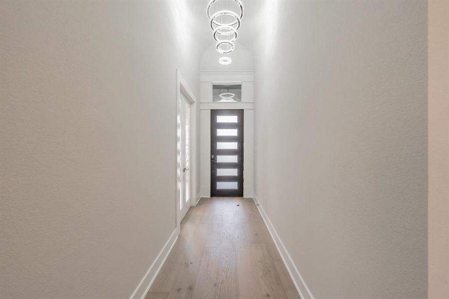 Entryway featuring hardwood / wood-style flooring and baseboards