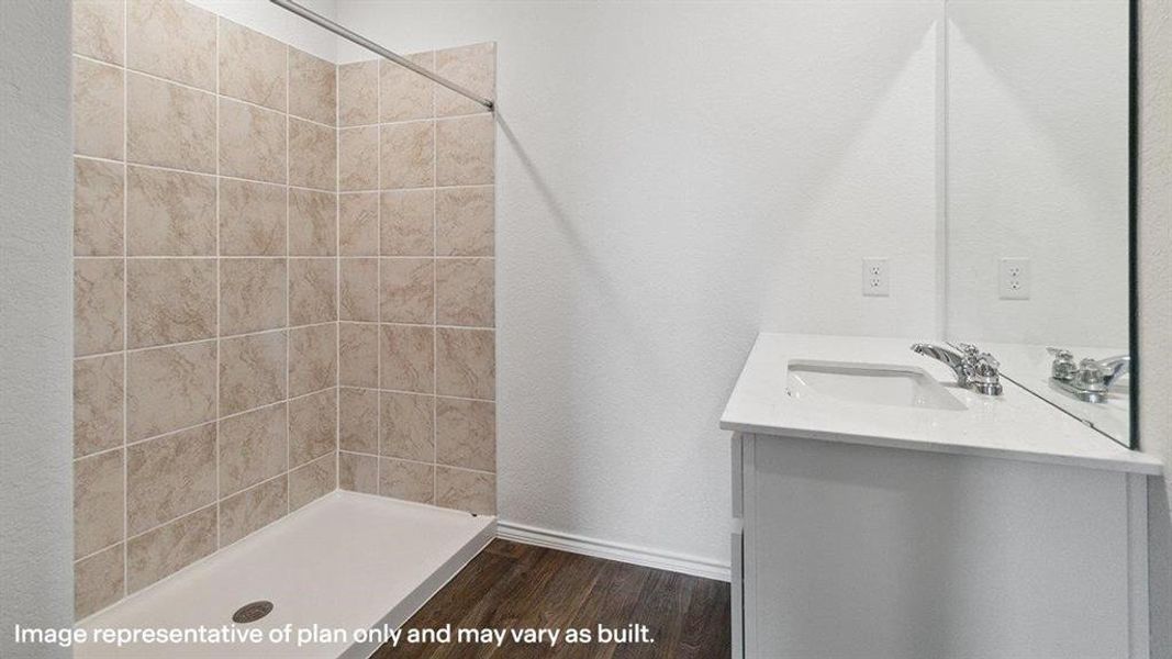 Full bath featuring vanity, a shower stall, and dark wood-style floors