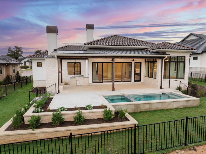 Outdoor patio with built in grill, fireplace, plunge pool and hot tub overlooking hole 9 on the Jack Nicklaus golf course