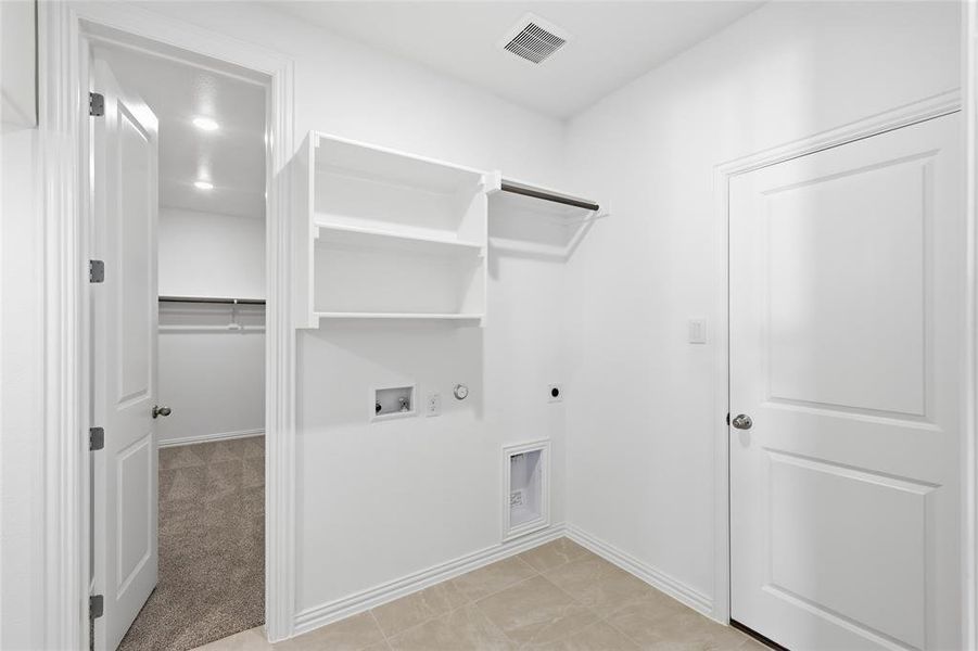 Laundry room featuring gas dryer hookup, light carpet, electric dryer hookup, and hookup for a washing machine