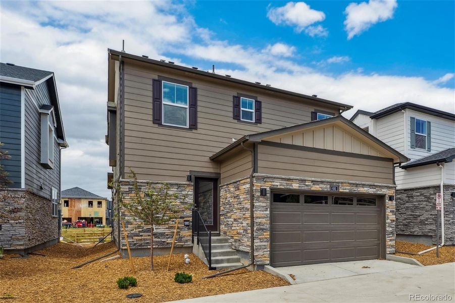 Front exterior of a new home in Horizon Uptown, Aurora, CO, highlighting curb appeal (Image 22).