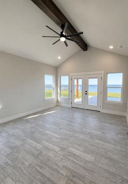 Vaulted ceiling with exposed wood-finish beam and recessed lighting Vaulted ceiling with exposed wood-finish beam and recessed lighting