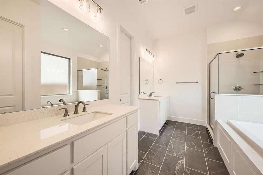 Full bathroom featuring a shower stall, marble finish flooring, recessed lighting, two vanities, and baseboards