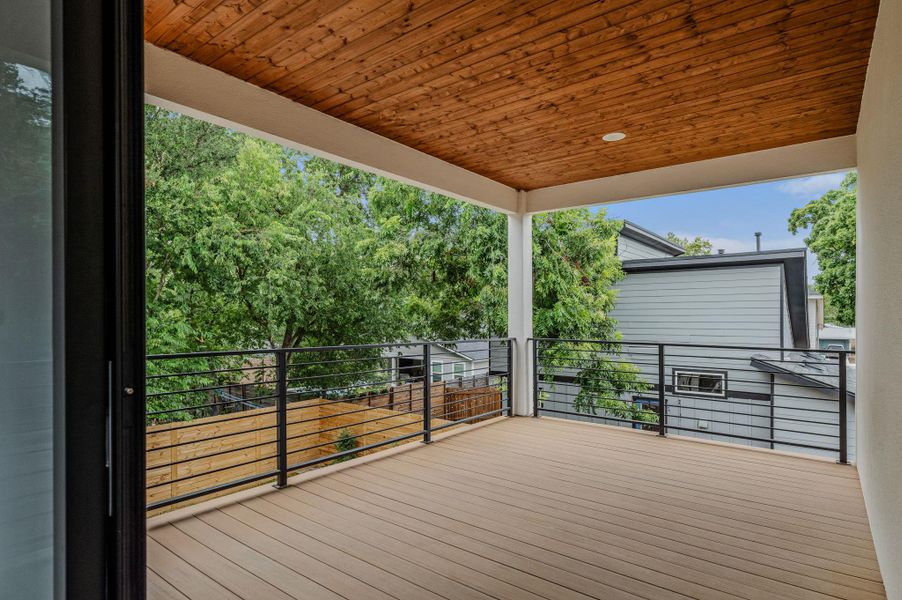 A spacious covered deck offers elevated views of lush greenery and neighboring homes, perfect for outdoor living. A spacious covered deck offers elevated views of lush greenery and neighboring homes, perfect for outdoor living.