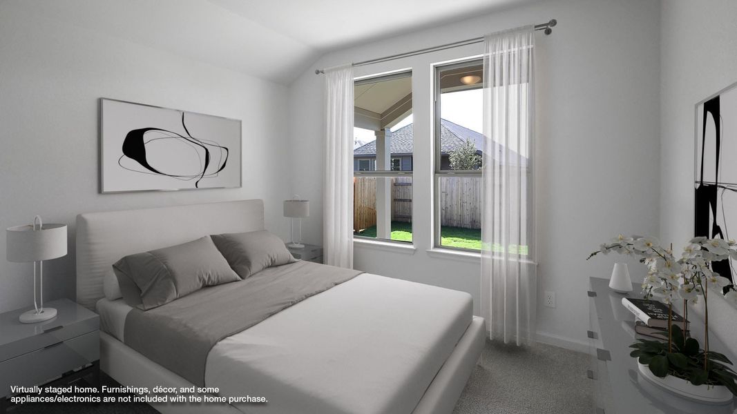 Carpeted bedroom with lofted ceiling and baseboards