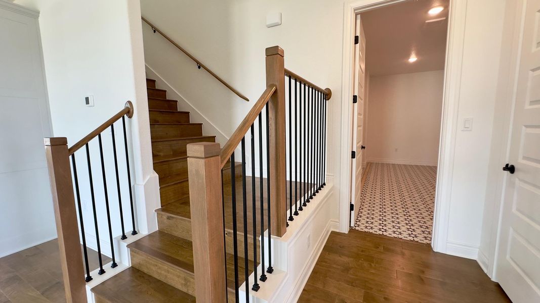 Staircase featuring wood finished floors and baseboards