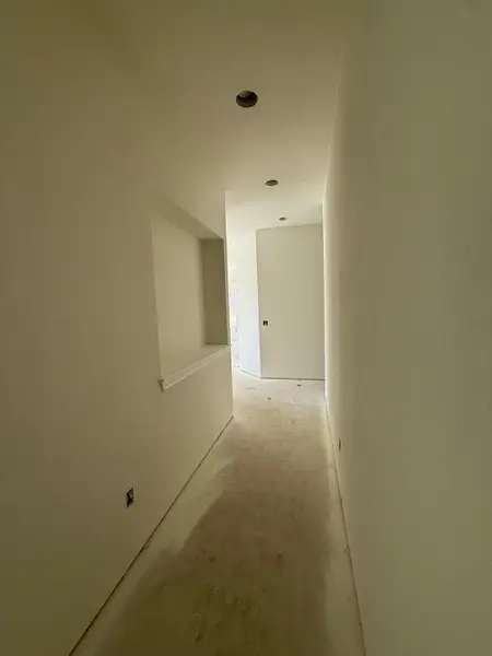 Hallway featuring concrete floors