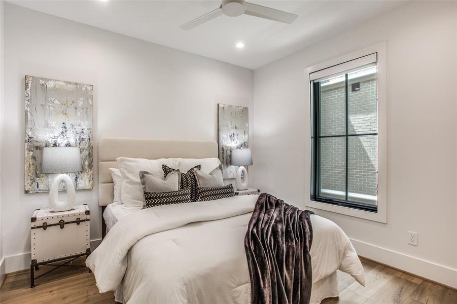 Bedroom featuring ceiling fan and light hardwood / wood-style flooring