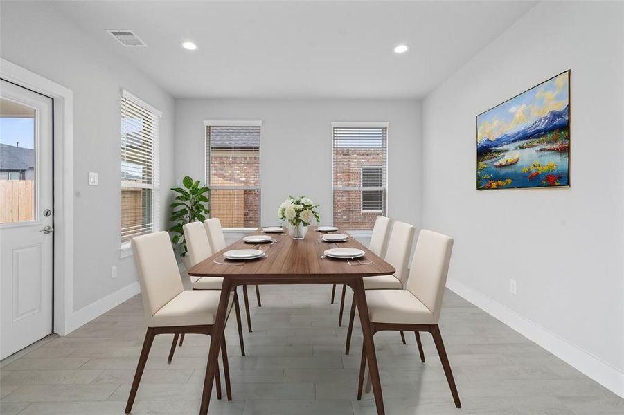 Make memories gathered around the table with your family and friends! This dining room features high ceilings, recessed lighting, large windows, and beautiful tile flooring!