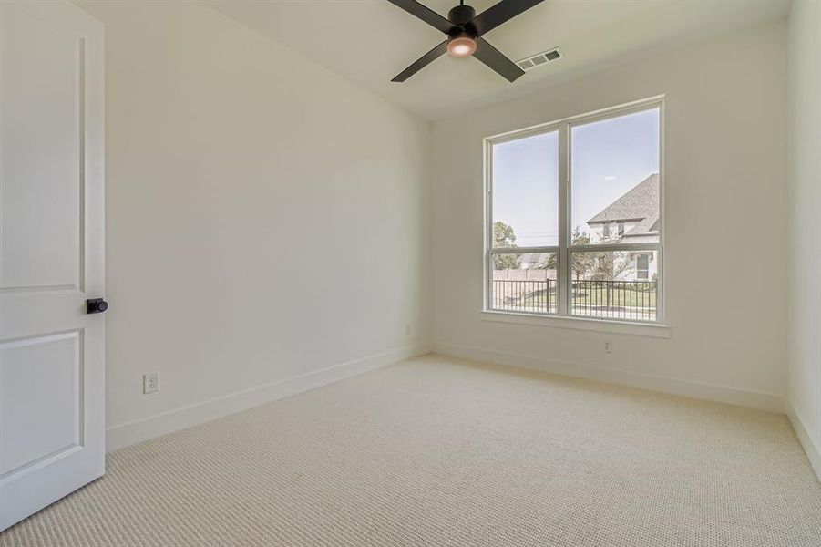 Spare room featuring light colored carpet and ceiling fan Spare room featuring light colored carpet and ceiling fan