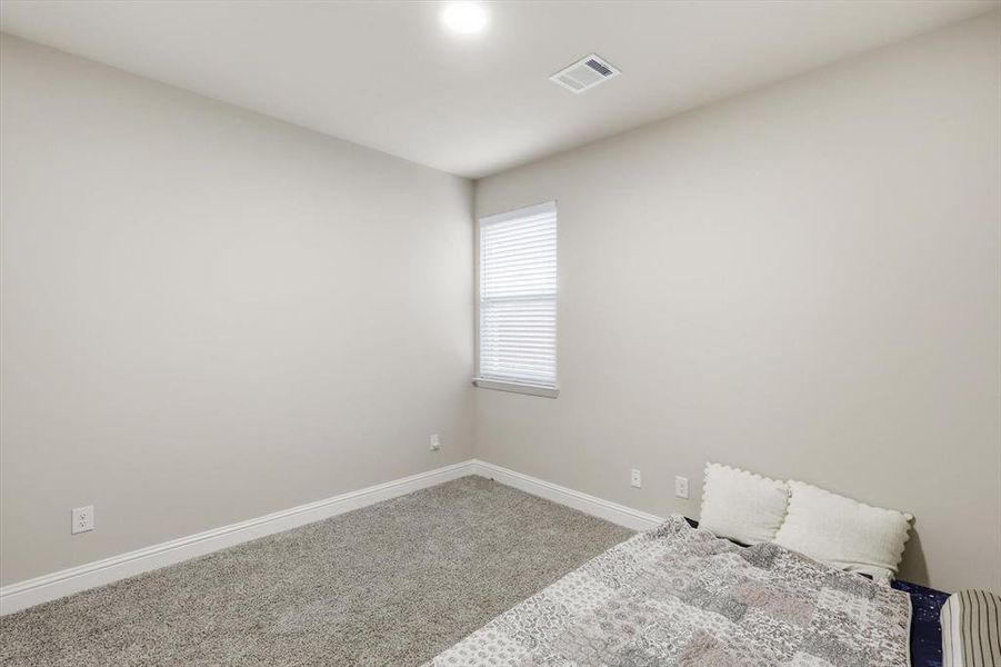 Unfurnished bedroom with baseboards and carpet