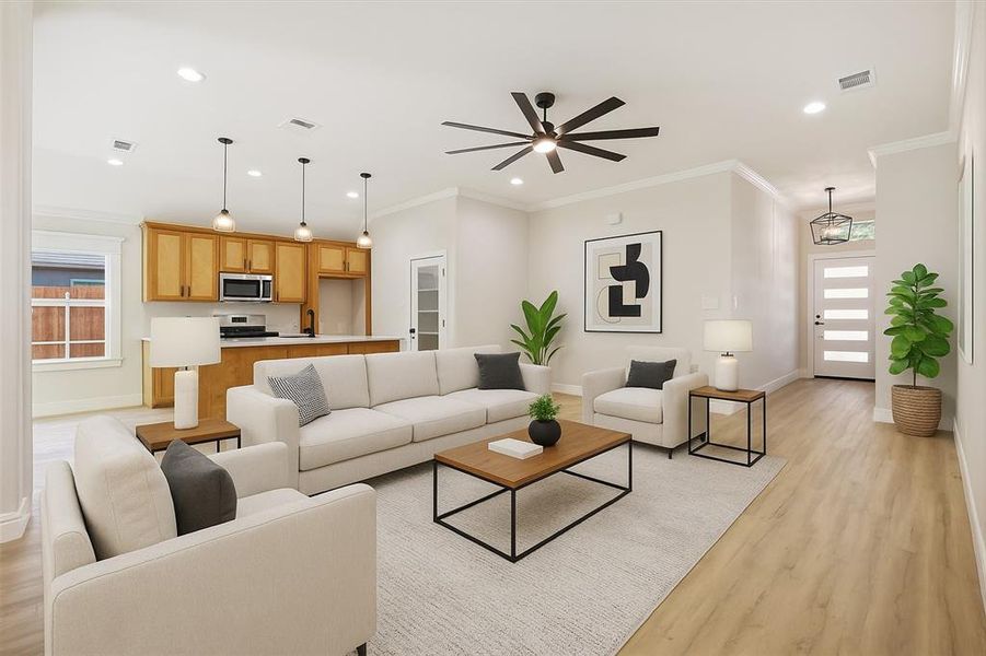 Living room featuring healthy amount of natural light, crown molding, recessed lighting, light wood-style floors, and ceiling fan