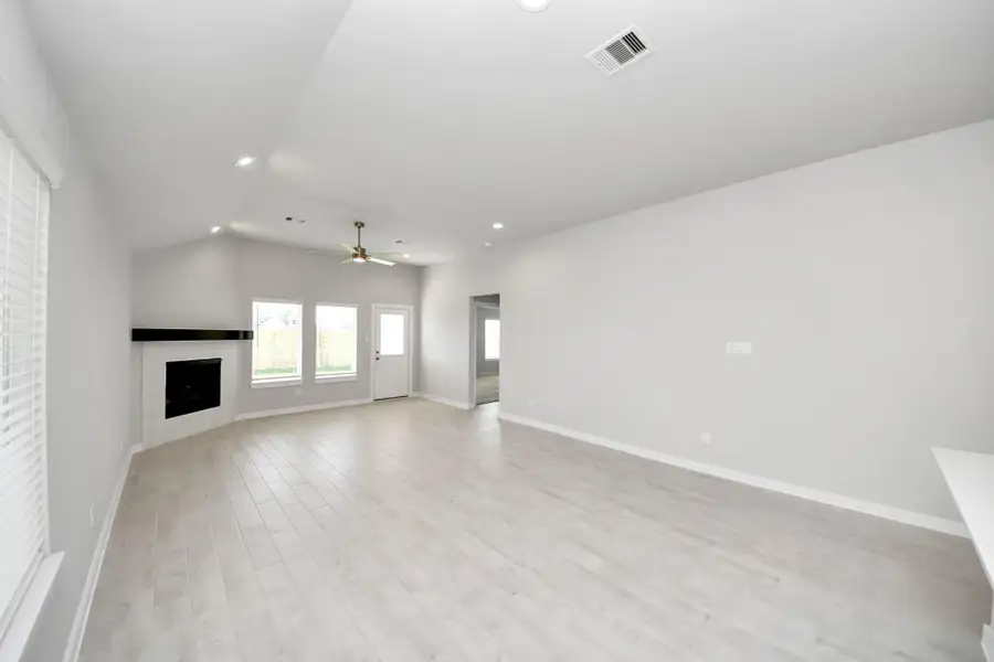 Welcome family and guests to your charming living room! With its high ceilings, recessed lighting, ceiling fan, custom paint, beautiful flooring, and large windows that let in abundant natural light, this room is perfect for gatherings. Sample photo of completed home with similar floor plan. Actual colors and selections may vary. Welcome family and guests to your charming living room! With its high ceilings, recessed lighting, ceiling fan, custom paint, beautiful flooring, and large windows that let in abundant natural light, this room is perfect for gatherings. Sample photo of completed home with similar floor plan. Actual colors and selections may vary.