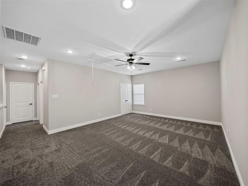 Spare room with attic access, recessed lighting, dark carpet, and a ceiling fan Spare room with attic access, recessed lighting, dark carpet, and a ceiling fan