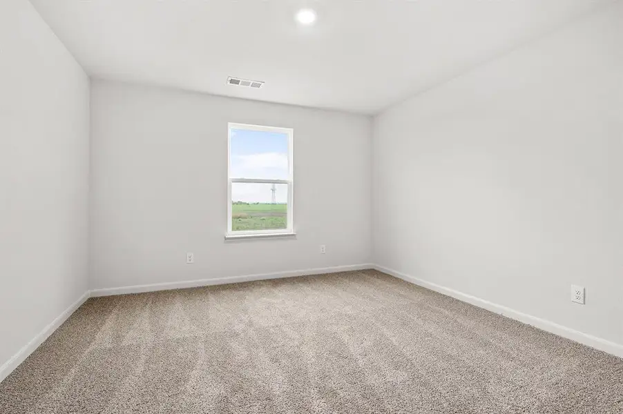 Spare room featuring light colored carpet and baseboards